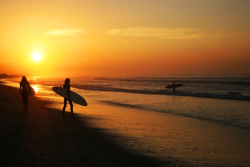 sunrise and surfers
